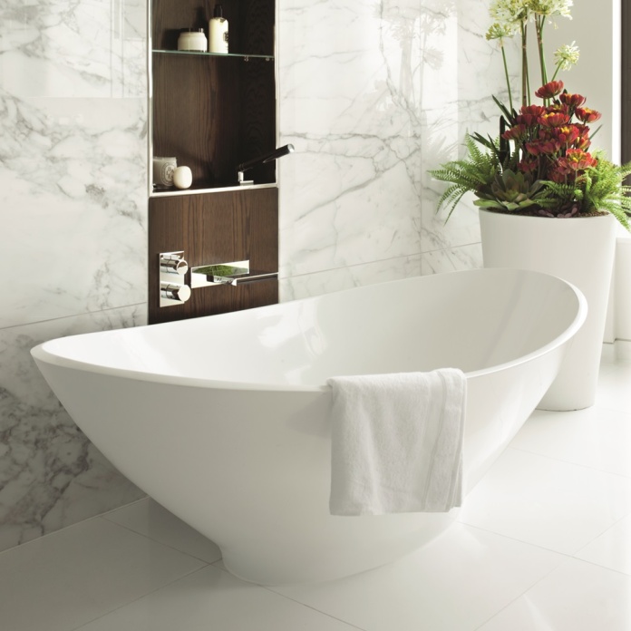 Product Lifestyle Image of BC Designs Kurv 1890 Freestanding Bath next to marble wall BAB005